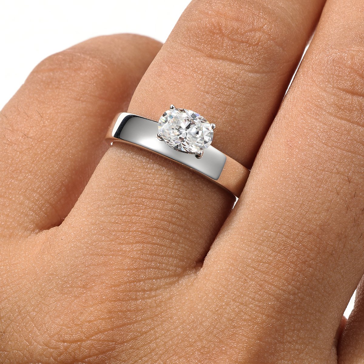 East-West Oval Moissanite Solitaire on a Polished Flat Band Ring - Image 4